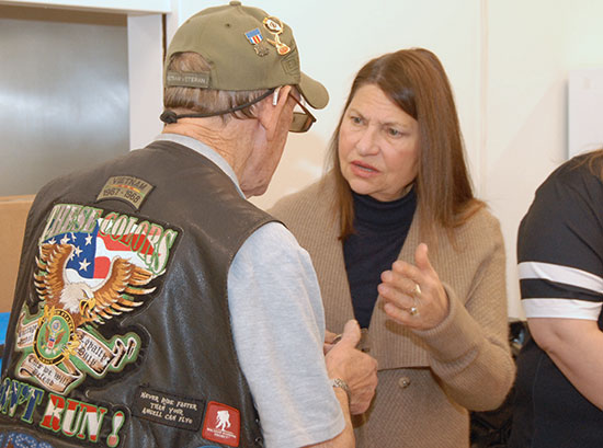 Trustee Diane Viverito chats with veteran.